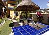 Charcoal BBQ and table by the pool shared by the 4 units