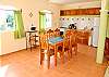Large sunny, breezy, well equipped kitchen with a table for 6.