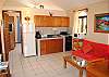 Living room with sofa bed and well equipped kitchen