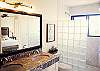 Spacious bathroom in the third floor master suite. Double sinks and large walk-in shower.