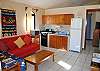 Living room with sofa bed and well equipped kitchen.