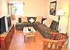 Comfortable living room with a sectional sofa, TV, DVD player.