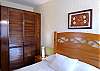 Smaller bedroom with large closet and private bathroom.