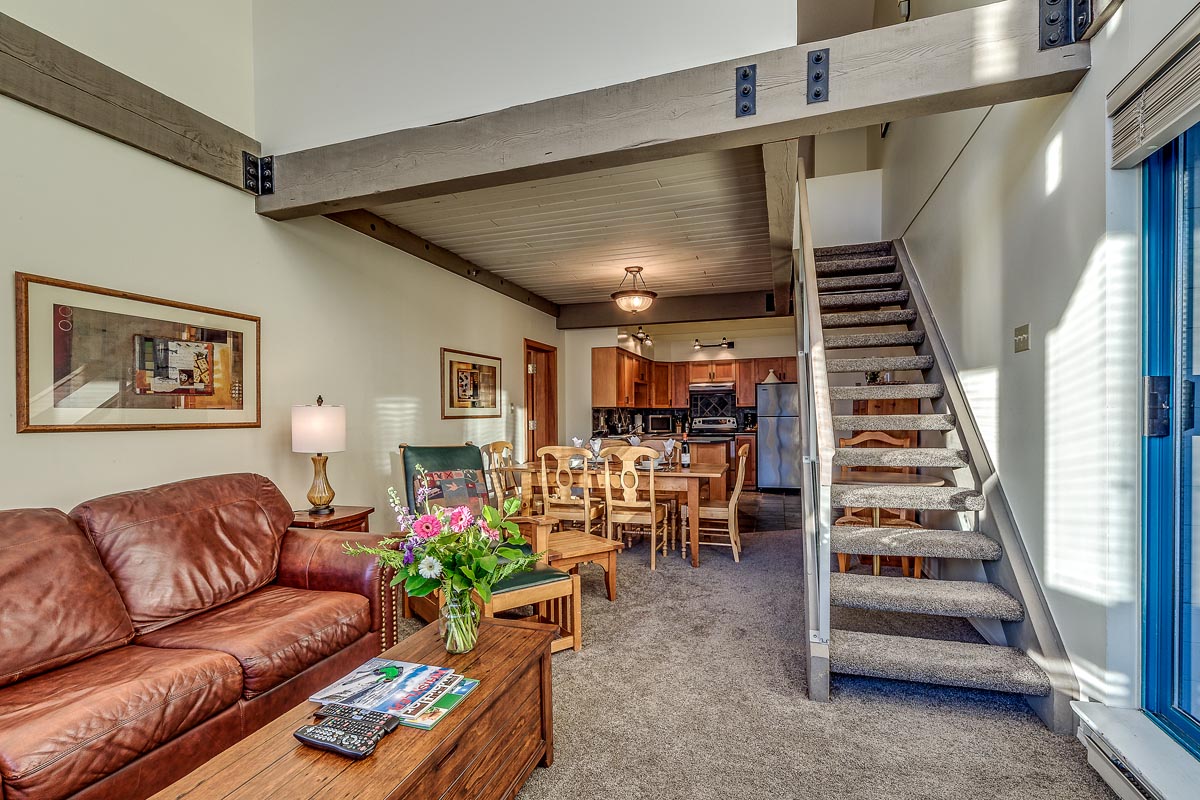 View of living room with stairs to loft bedroom