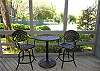 Dining table on screened porch for enjoying the tennis views.