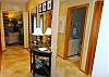 Mirrored entry hallway leading to living area.