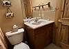 A full bathroom is also available on the lower level of the house. It has a single-bowl vanity, toilet, and a shower/tub combo.