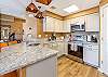 Modern kitchen with granite countertops and LG stainless steel appliances.