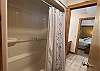 This bathtub/shower combo is shared between bedrooms 2 and 3 and is accessible via each bedroom's private powder room.