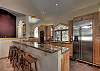Part of the Great Room with Monogram Appliances, granite counters, stone floor and mountain views