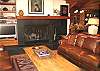 living room with TV, fireplace, ample seating, next to kitchen and dining area