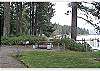 Homeowner Beach with two piers, grass lawns, and many free picnic tables each with a BBQ