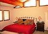 Master BEdroom with king bed and high windows