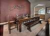 Dining table seats ten with kitchen buffet nearby