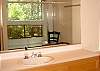 Private bathroom for Bedroom 1 with Tub/Shower and tree view yet private