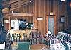 Kitchen, bar seating for four, and living room