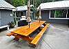 Patio Area withe a huge wood Picnic Table and Gas BBQ.  Gazebo, Garage and Bonus Room in the background.