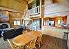 Great Room looking towards the Kitchen and log stairs leading to upper level bedrooms.