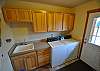 Laundry Room with door leading to the sports court, side deck and Hot Tub.