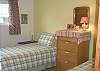 This room has 2 Single beds with cozy new comforters, dresser, closet for hanging clothes, and stackable washer and dryer.