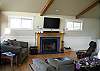 Comfortably furnished living room on the upstairs level of this lovely contemporary style home with high vaulted ceilings.