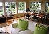 Partial view of living room & dining area, you'll love the light airy feel of high vaulted ceilings and all encompassing windows w/fabric pleated shades to bring in lot's of light during the day and nice privacy at night.