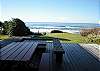 Full west deck provides great ocean views, picnic table, deck table with benches which converts into a firepit when the table top is removed.  Large grassy yard, nicely landscaped.
