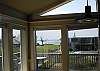 Panoramic windows and sliding glass doors provide an open airy floor plan and great views from the Living, Dining & Kitchen areas of this spacious home.