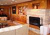 Cozy up to a large woodburning fireplace while you take in the "cabin feel" ambience that the wood interior walls provide.