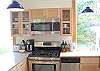 Prepare meals on the gas range/oven with center griddle/grill next to quartz countertops, as you enjoy ocean and forest views. Beautiful cabinetry with plenty of dishware and cookware provided for a great cooking experience.