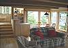 Just a few steps down from the main living room is a cozy family & dining room encompassed with more ocean and forrested view windows and leading to a full west deck and the Master bedroom.