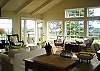 Light and airy great room is comfortably furnished with charming decor.