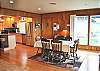 This dining table extends out to comfortably seat 8 and there are 4 bar stools at the kitchen counter. Lovely flooring throughout kitchen &amp; dining room.
