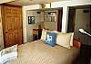 Comfortable Queen bedroom, encompassed with panoramic ocean view windows, large walk-in closet, door to full west deck &amp; outdoor rocking chairs to enjoy secluded forrested landscape &amp; ocean views.