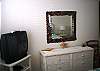 White wicker furniture &amp; artistic flaired decor give a warm presence to the Master bedroom.  Cable TV in this room as well.