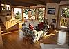 SW view of the Dining/Sitting room windows which provide plenty of sunlight.  You can also see steps(L) which leads to the Kitchen &amp; "Ocean room" living area on the upper level. Two flights of steps off the Kitchen lead to the downstairs level.
Beautiful hardwood &amp; tile floors throughout this lovely home with great attention to details of the woodworking as well.