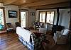 Cozy gas fireplace in this comfortable Sitting/Dining room on Main entry level. Full ocean and forrest views from every window in this comfortable &amp; cozy room.
Looking into the Master bedroom in the next room, private sliders can be closed to provide full privacy from this room.