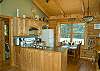 Open floor plan with sunny kitchen and dining space.