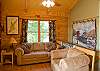 Cozy living room with lots of glass, hardwood floors and gas burning fireplace.