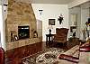 Comfortable living room with gas fireplace and queen HB