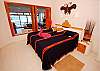 Master bedroom with king bed and ocean views.-Thumbnail