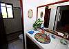 Guest bathroom with single vanity and shower.-Thumbnail