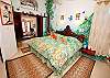 Master bedroom with king sized bed and shutters for bay views.-Thumbnail