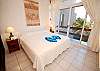 La Sirena condos # 8, Guest bedroom with garden view terrace.-Thumbnail
