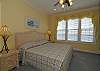 This is the spacious master suite with king bed, jacuzzi tub and separate bathroom.  Bright and airy 2nd level bedroom with a lovely ocean view.