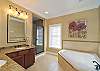 Master Bath Features a Garden Tub, Double Sinks, Separate Shower with Glass Enclosure