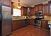 Fully equipped kitchen features upgraded cabinetry, stainless steel appliances, separate icemaker and a smooth top stove