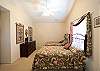 Upstairs bedroom with 2 full beds and high ceilings.