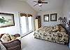 Spacious 2nd floor front bedroom with high ceilings for an open and airy feel. Door opens onto the covered oceanview porch.