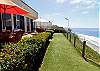 Large patio overlooking the ocean with grass area